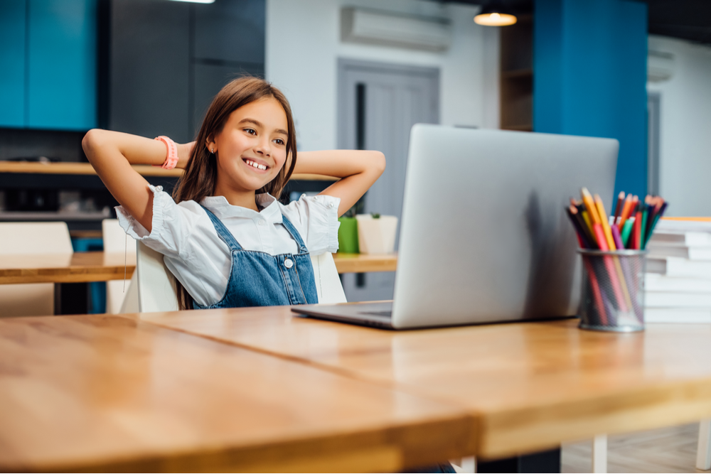 Young student at a desk with computer